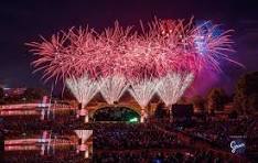 Fireworks By Grucci illuminating the sky over the Eisenhower Park concert stage